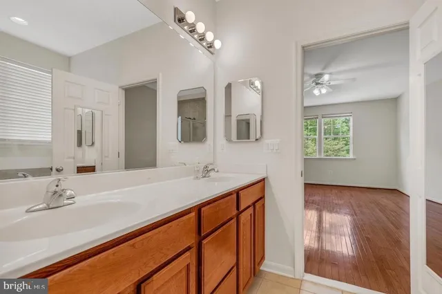 a en suite bathroom with a sink double vanity and a mirror