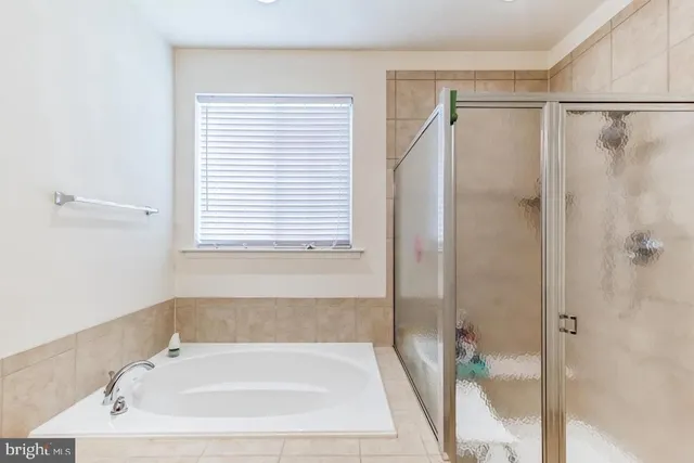 a bathroom with a bathtub and a shower