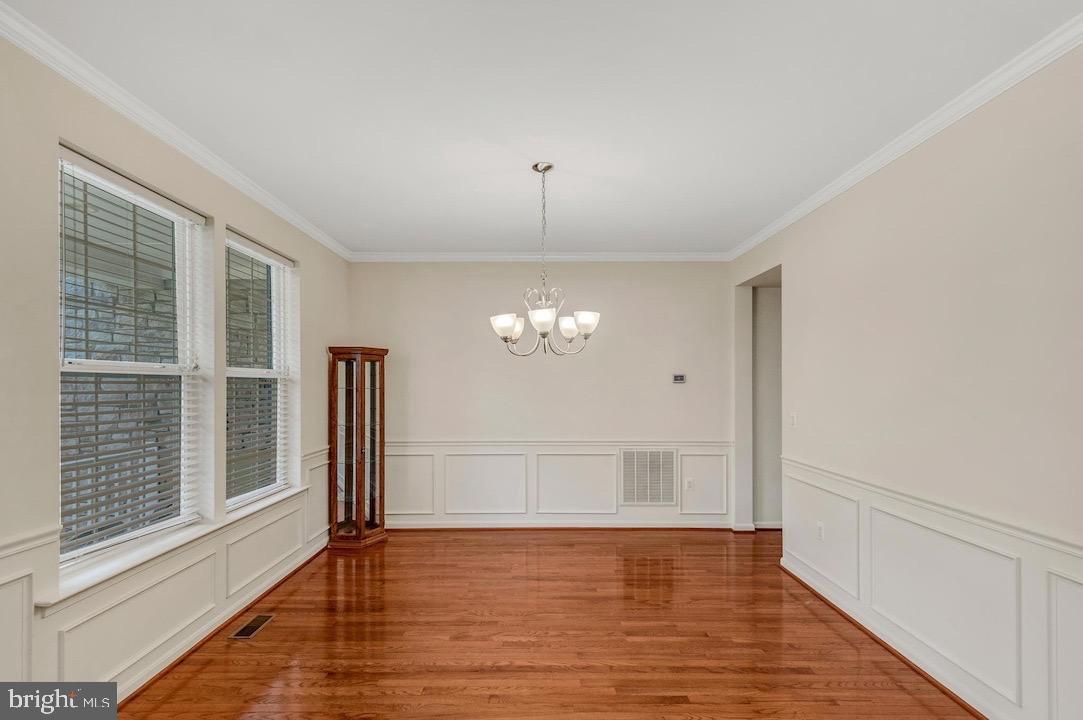 18776 Pier Trail Drive Triangle, VA 22172 - Photo 16 of 32 a view of an empty room with wooden floor and a window