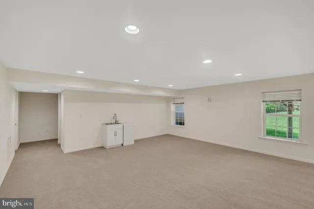 an empty room with closet and windows