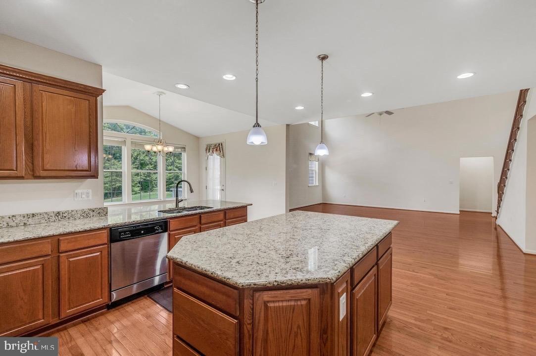 18776 Pier Trail Drive Triangle, VA 22172 - Photo 5 of 32 a kitchen with granite countertop kitchen island sink stove and wooden floor