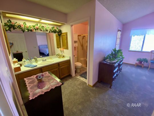 812 Charles Court Ridgecrest, CA 93555 - Photo 27 of 32 a bathroom with a sink a mirror and a shower