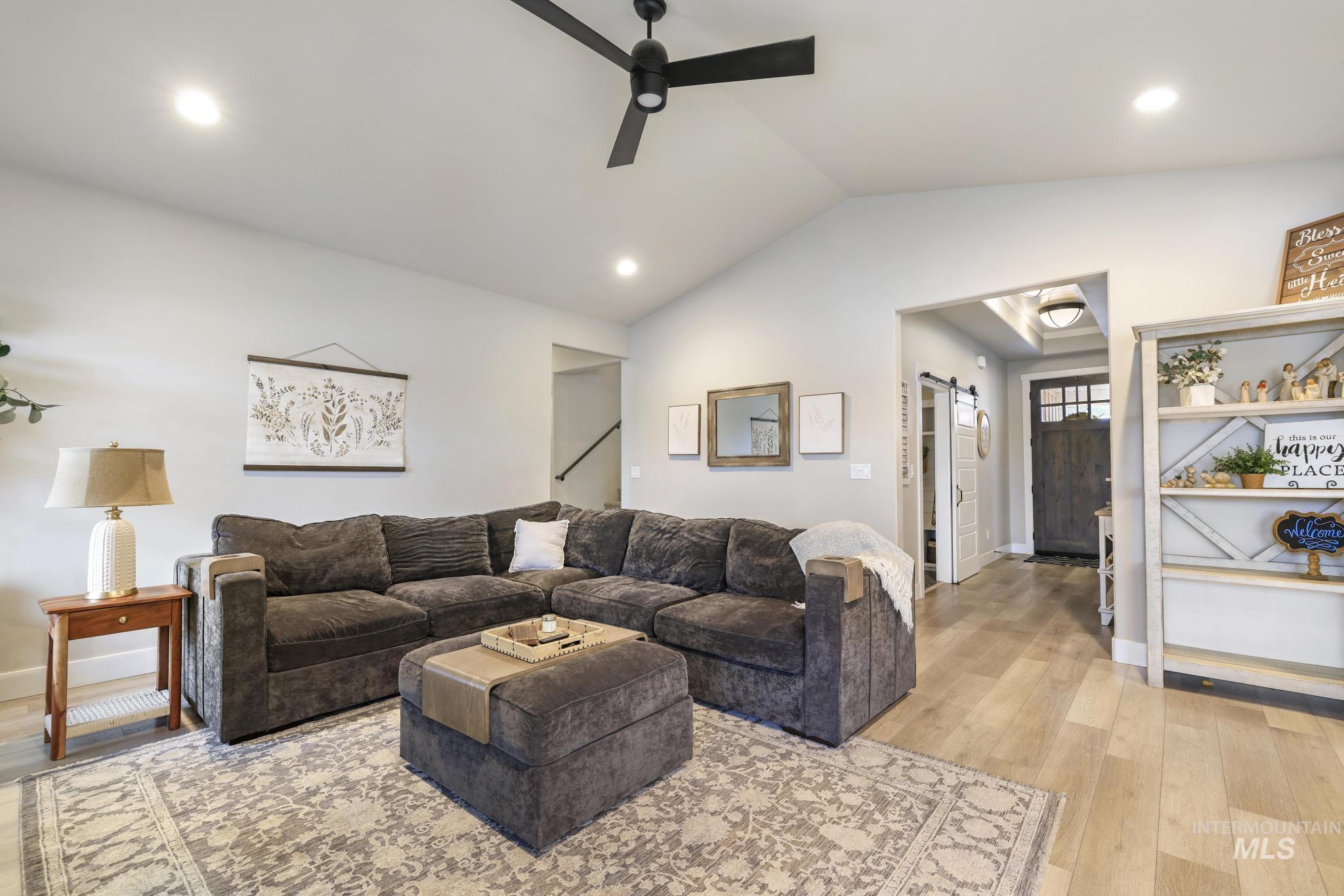 3103 Moonrise Road Twin Falls, ID 83301 - Photo 5 of 42 Living area featuring light wood finished floors, a barn door, ceiling fan, vaulted ceiling, and recessed lighting
