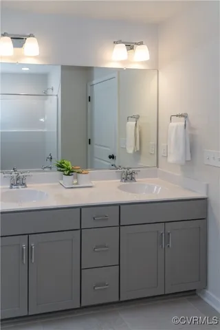 a bathroom with a double vanity sink and a mirror