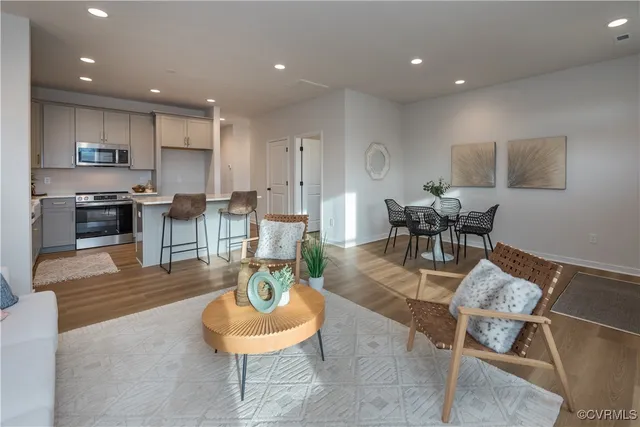 a living room with furniture and kitchen view