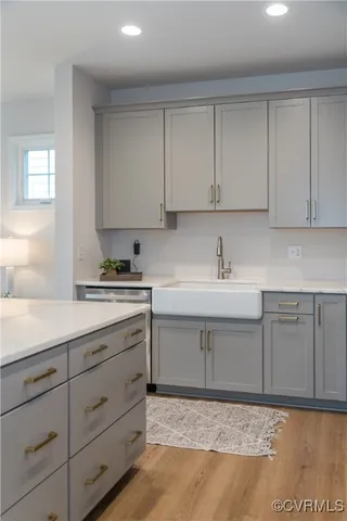 a kitchen with cabinets appliances and a sink