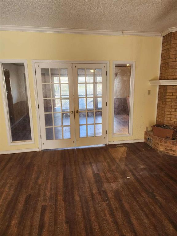 1316 Edna Street Commerce, TX 75428 - Photo 6 of 16 a view of an empty room with wooden floor and a window