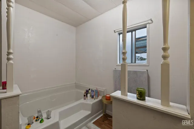 a bathroom with a bathtub and a window