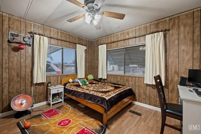 a living room with furniture a flat screen tv and a window