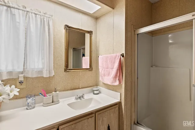 a bathroom with a sink vanity and mirror