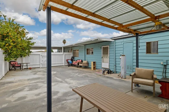 a view of a patio with table and chairs and potted plants