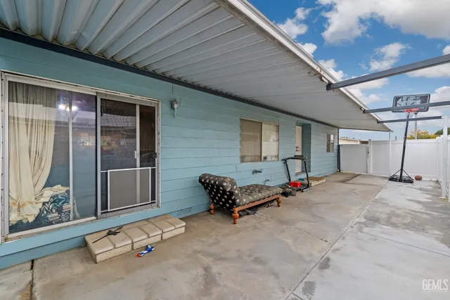 a wooden bench sitting in front of a building