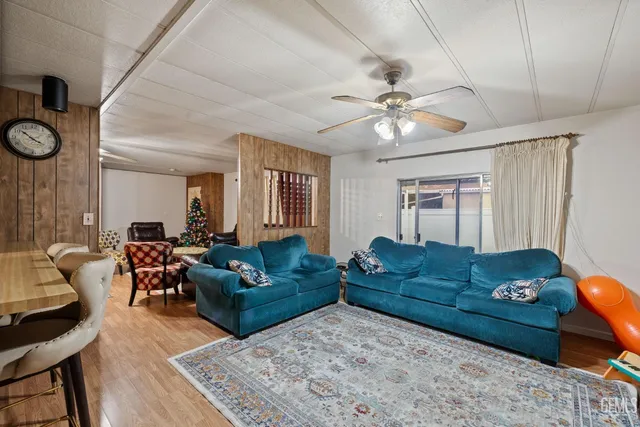 a living room with furniture ceiling fan and a rug