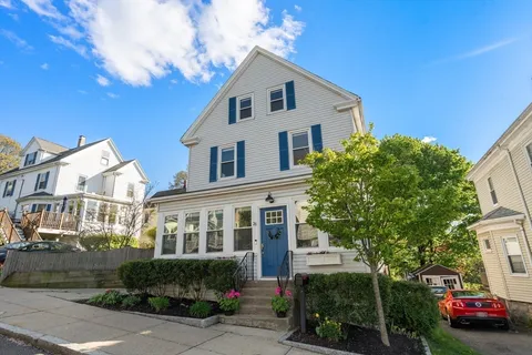 a front view of a house with a garden