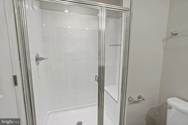 a bathroom with a glass shower door