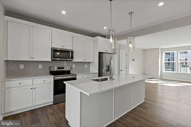 a kitchen that has a lot of counter space and wooden floor