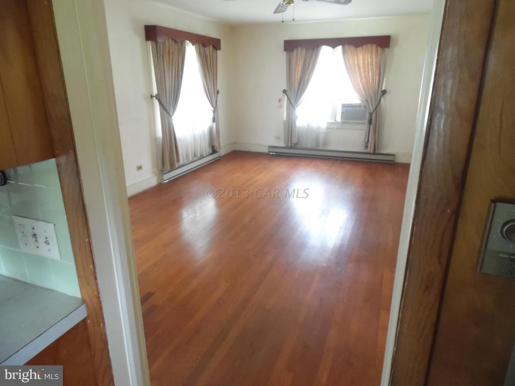 34405 Rounds Road Pittsville, MD 21850 - Photo 3 of 18 an empty room with wooden floor and windows