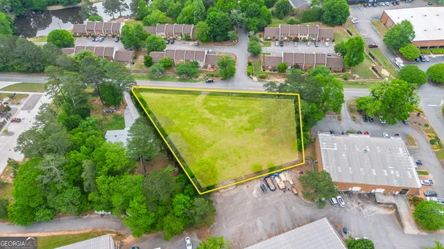 an aerial view of a house with a garden and swimming pool