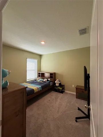 a bedroom with a bed and window