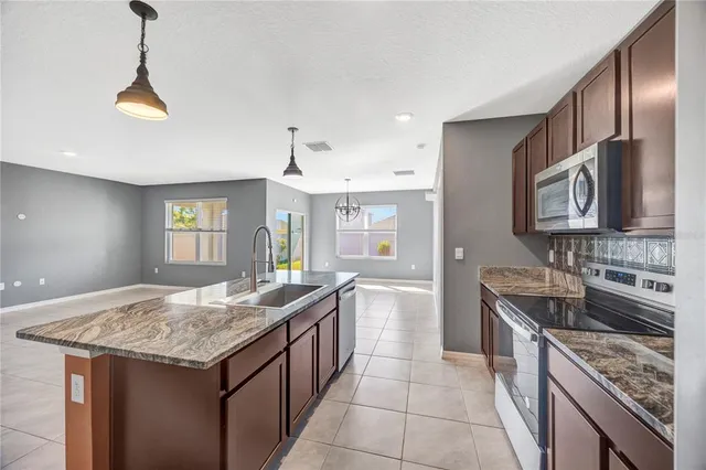 a bathroom with a granite countertop toilet and a shower