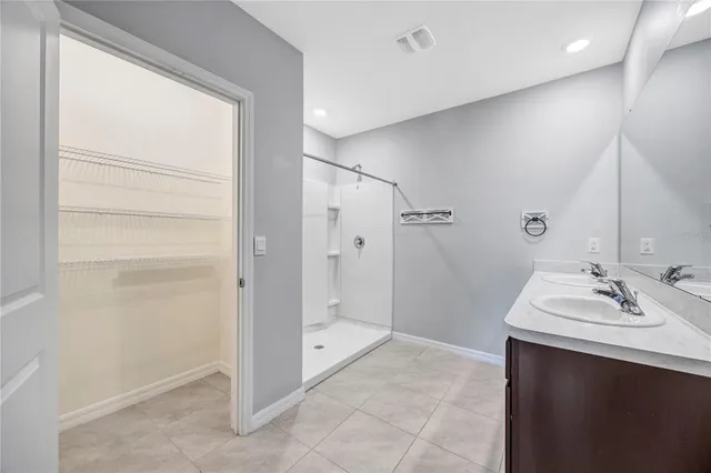 a front view of a house with a garden and trees