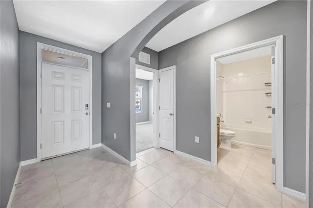 a view of a hallway with bathroom and a sink