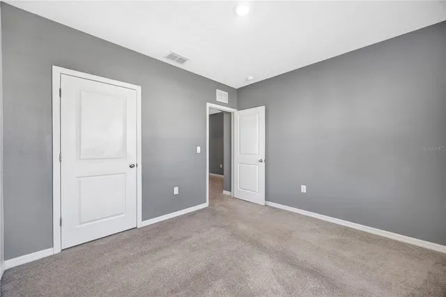 a kitchen with stainless steel appliances granite countertop wooden cabinets a refrigerator a sink a stove and a wooden floors