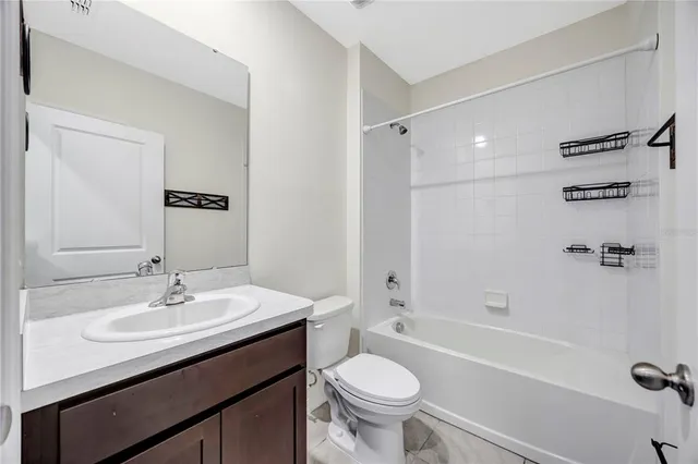 a kitchen with stainless steel appliances granite countertop a stove refrigerator and a sink