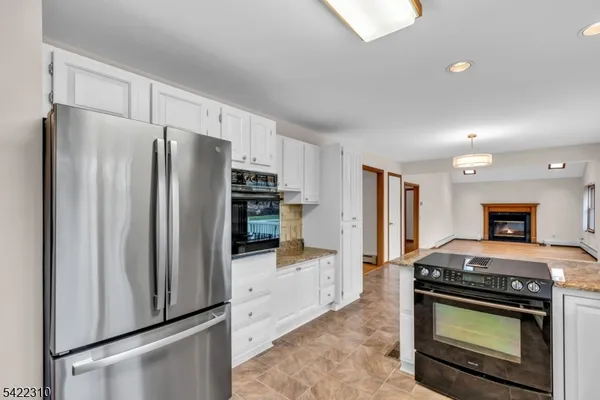 a view of empty room with a fireplace and large window