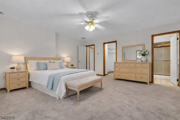 a spacious bedroom with a bed and a chandelier