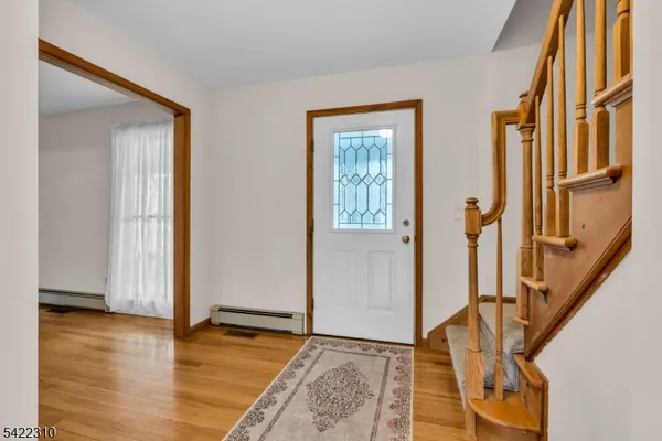 a view of an empty room and wooden floor