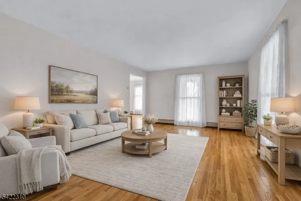 a view of a room with wooden floor and a chandelier