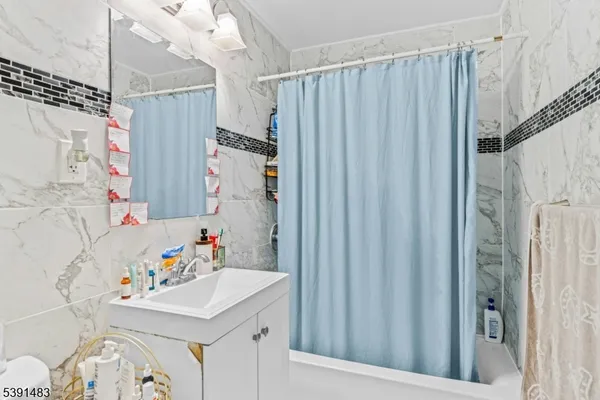 a bathroom with a sink a bed and a window