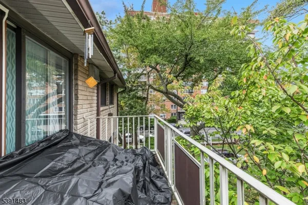 a balcony with trees in front of it
