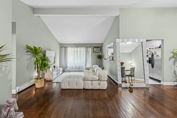 a bedroom with a bed and a potted plant
