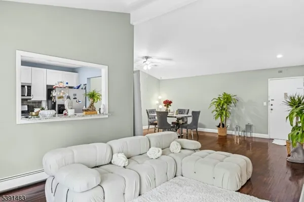 a living room with furniture and a potted plant