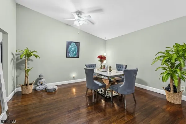 a view of a dining room with furniture and wooden floor