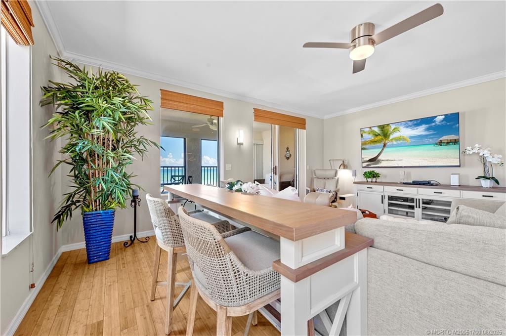 4651 Northeast Ocean Boulevard, Unit B26 Stuart, FL 34996 - Photo 12 of 35 a dining room with furniture and wooden floor
