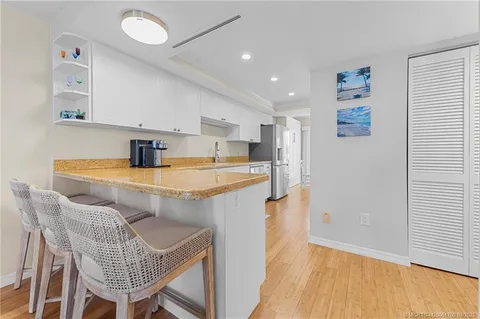 a kitchen with stainless steel appliances granite countertop a sink refrigerator and microwave