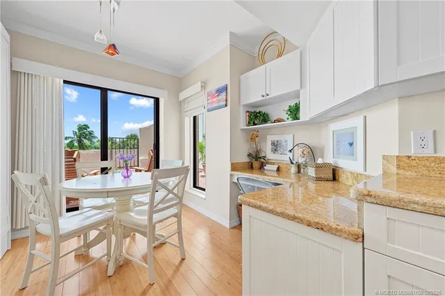 a kitchen with granite countertop lots of counter top space and living room