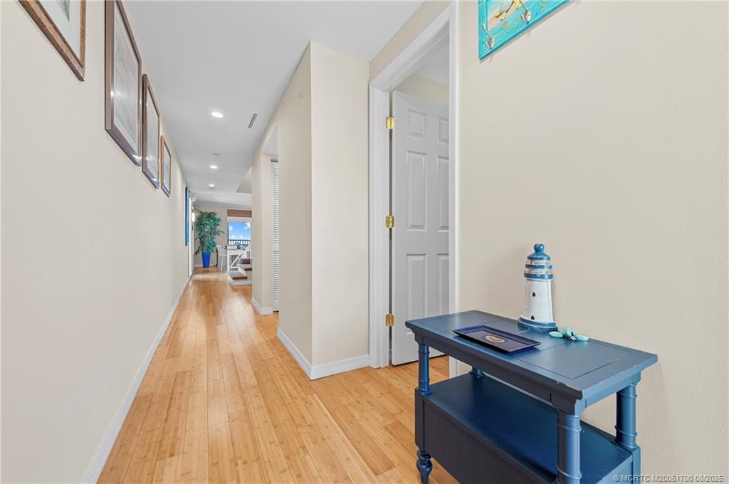 4651 Northeast Ocean Boulevard, Unit B26 Stuart, FL 34996 - Photo 20 of 35 a view of a hallway with wooden floor and staircase