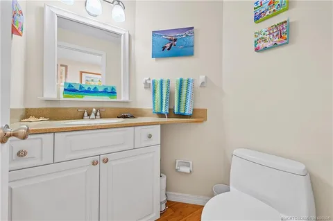 a bathroom with a sink a mirror and toilet