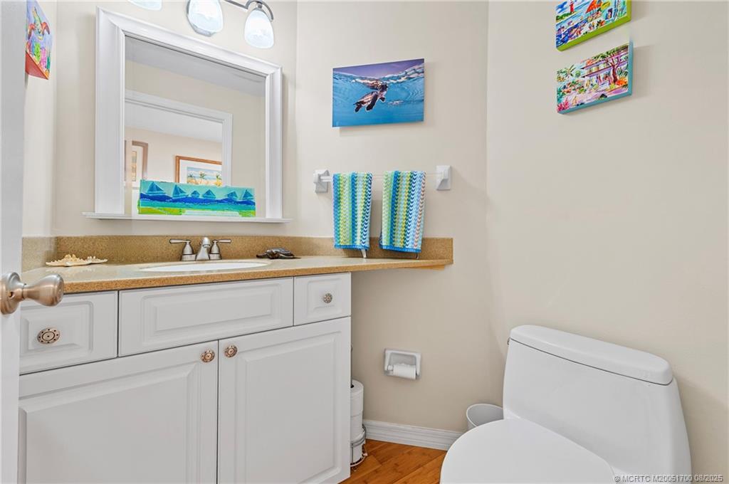 4651 Northeast Ocean Boulevard, Unit B26 Stuart, FL 34996 - Photo 21 of 35 a bathroom with a sink a mirror and toilet
