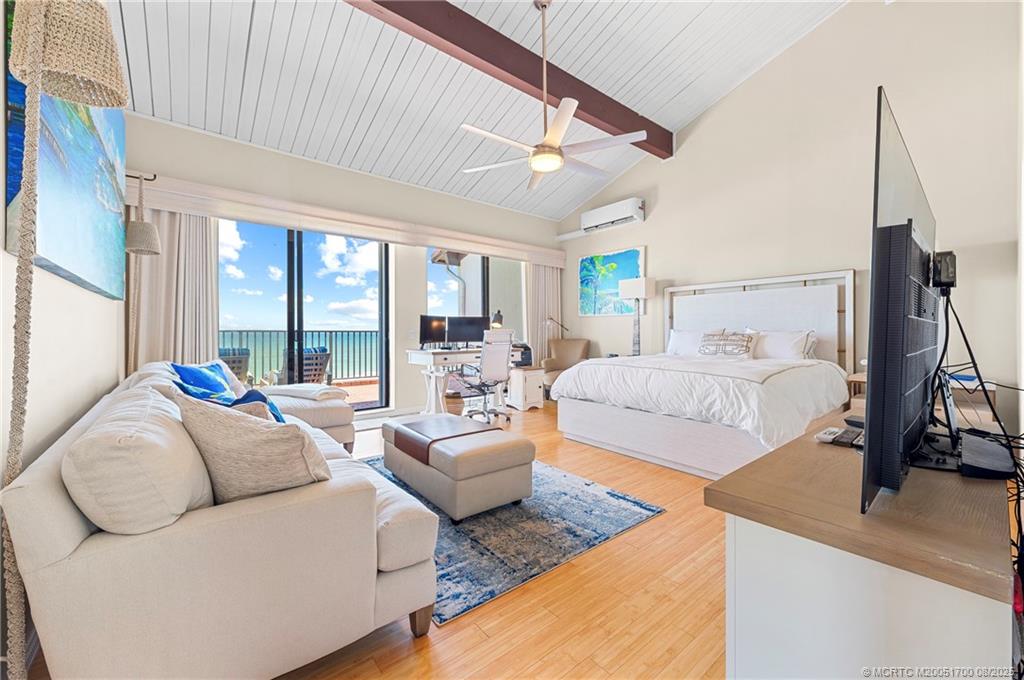 4651 Northeast Ocean Boulevard, Unit B26 Stuart, FL 34996 - Photo 23 of 35 a bedroom with furniture and a large window