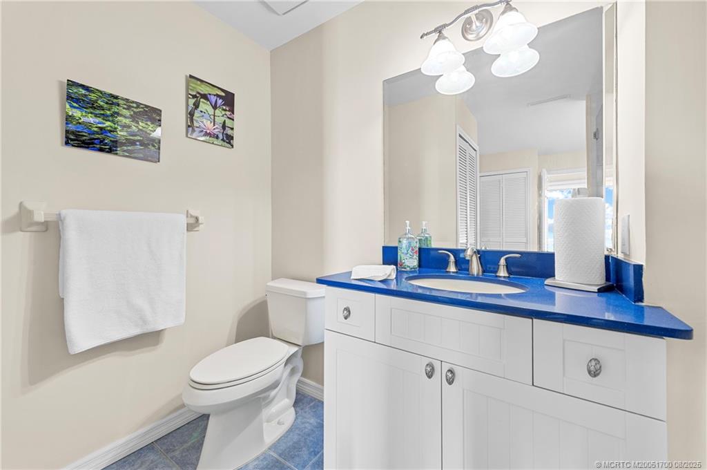 4651 Northeast Ocean Boulevard, Unit B26 Stuart, FL 34996 - Photo 27 of 35 a bathroom with a toilet a sink and mirror