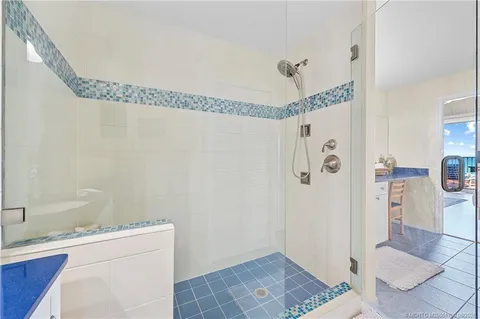 a bathroom with a granite countertop shower a sink and a toilet