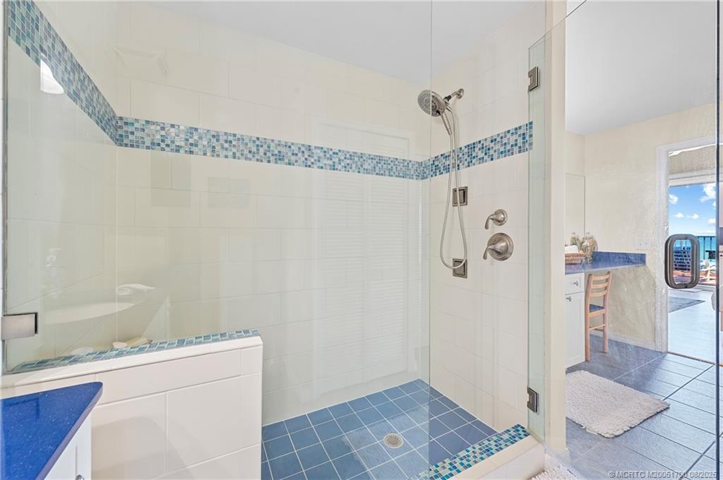4651 Northeast Ocean Boulevard, Unit B26 Stuart, FL 34996 - Photo 28 of 35 a bathroom with a granite countertop shower a sink and a toilet