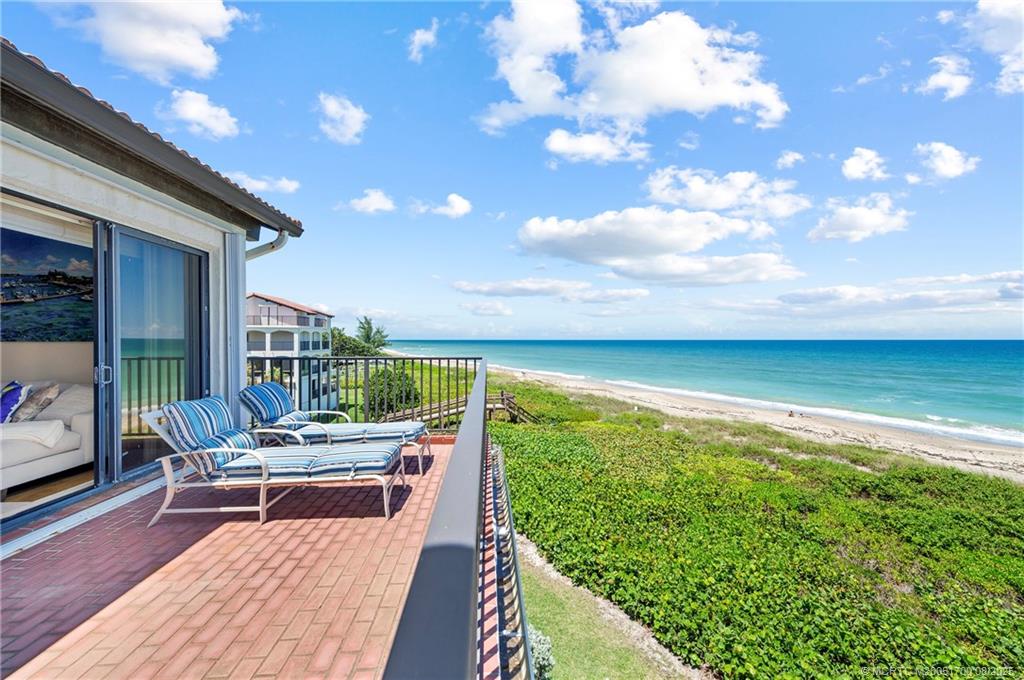 4651 Northeast Ocean Boulevard, Unit B26 Stuart, FL 34996 - Photo 31 of 35 a balcony with furniture and city view