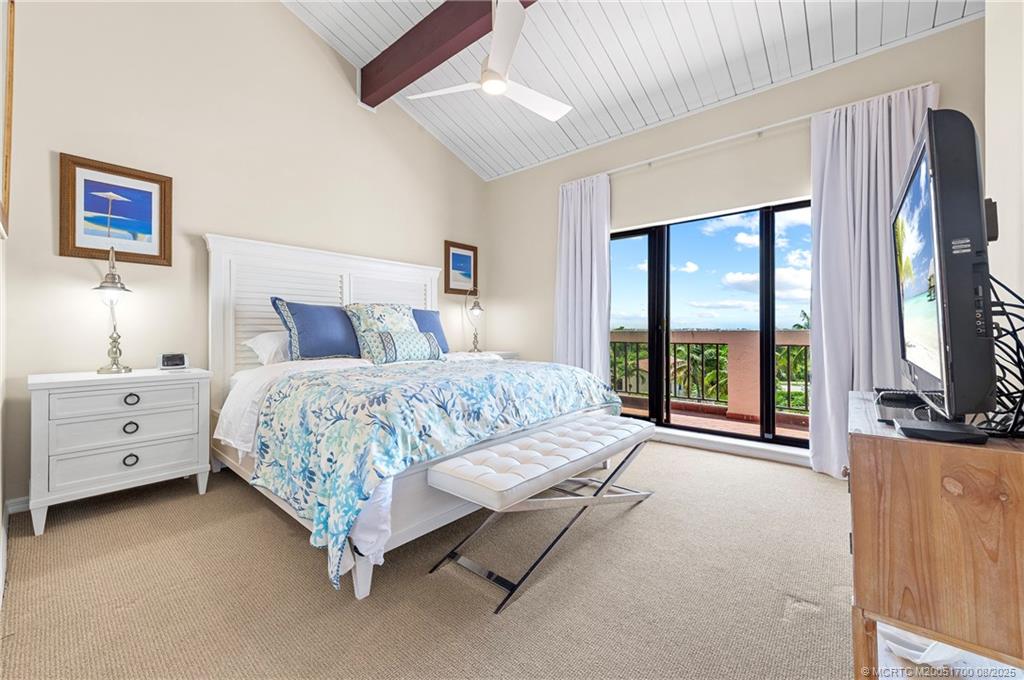 4651 Northeast Ocean Boulevard, Unit B26 Stuart, FL 34996 - Photo 32 of 35 a spacious bedroom with a large bed and a flat tv screen on dresser