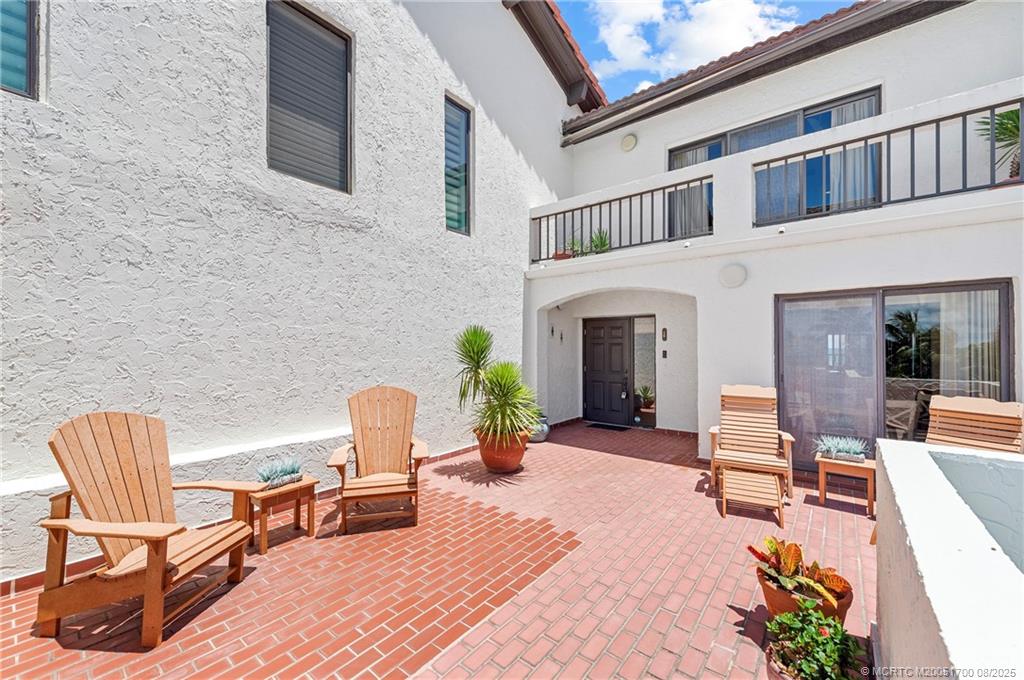 4651 Northeast Ocean Boulevard, Unit B26 Stuart, FL 34996 - Photo 35 of 35 a view of a patio with chair and tables